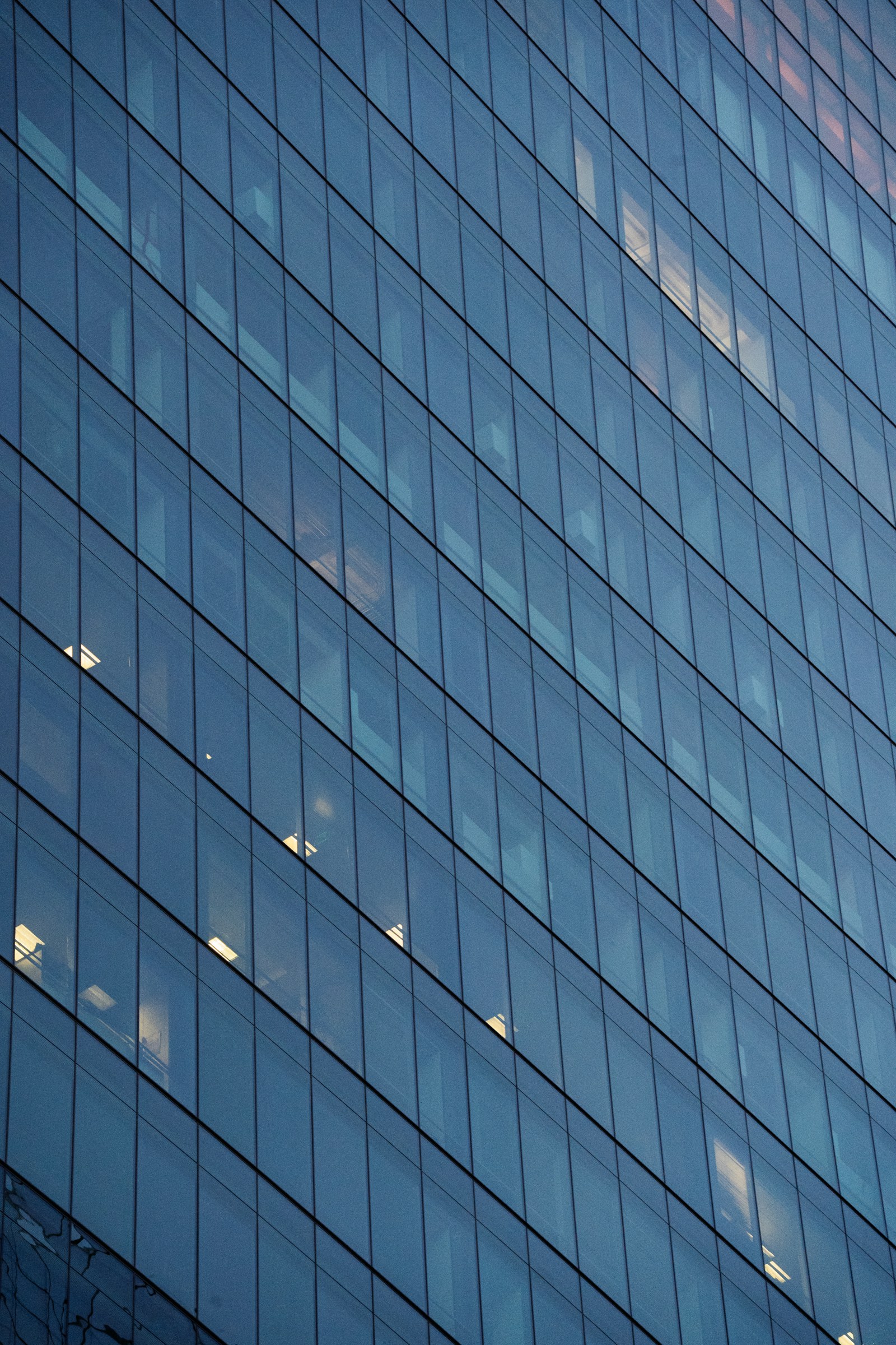 Geometric blue glass facade of a modern building